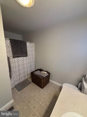 a bedroom with a bed and a stove with wooden floor