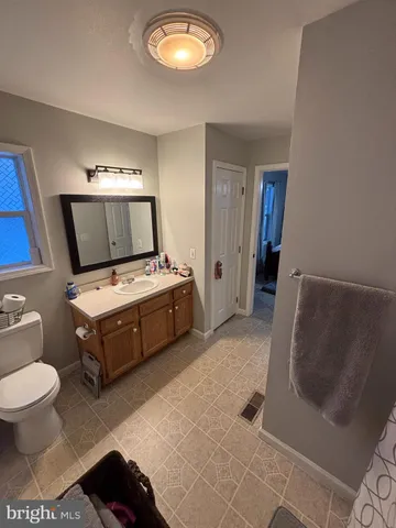 a bedroom with a bed and a mirror