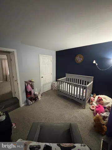 a bedroom with bed and wooden floor