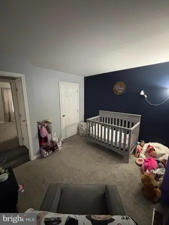 a bedroom with bed and wooden floor