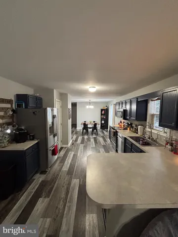 a living room with lots of furniture and kitchen view