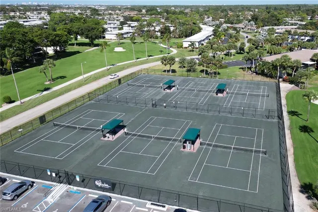 an aerial view of residential houses with outdoor space and street view