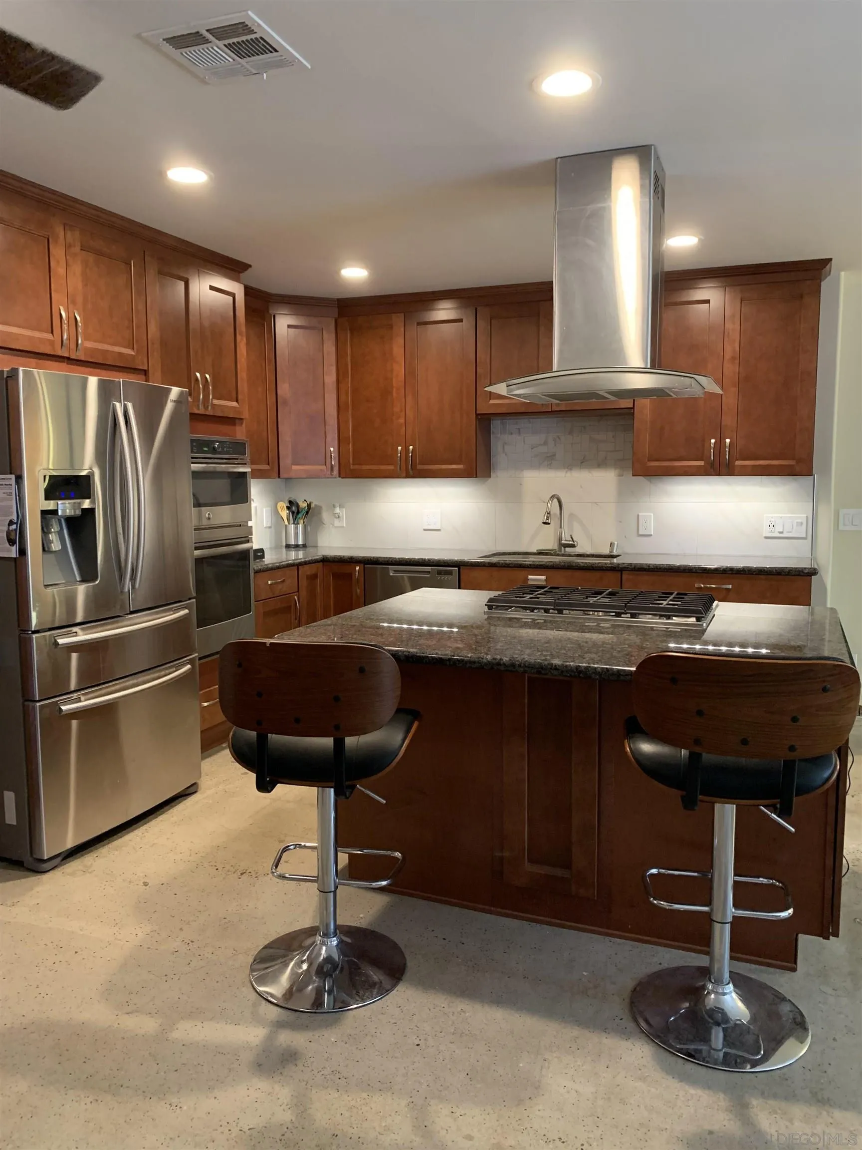 9935 Blossom Valley Road El Cajon, CA 92021 - Photo 19 of 36 a kitchen with stainless steel appliances granite countertop a sink refrigerator and cabinets