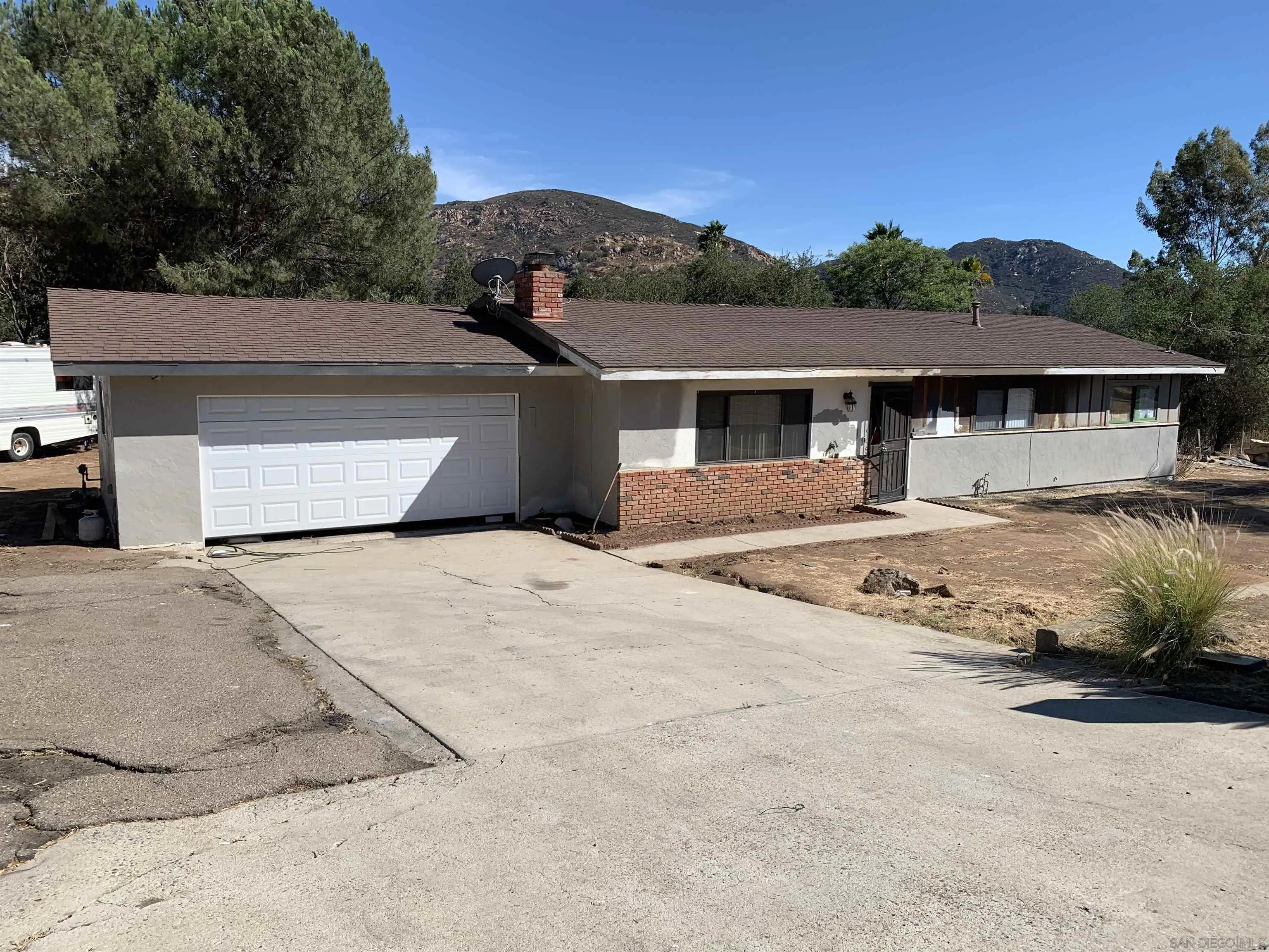 9935 Blossom Valley Road El Cajon, CA 92021 - Photo 2 of 36 a front view of a house with a yard