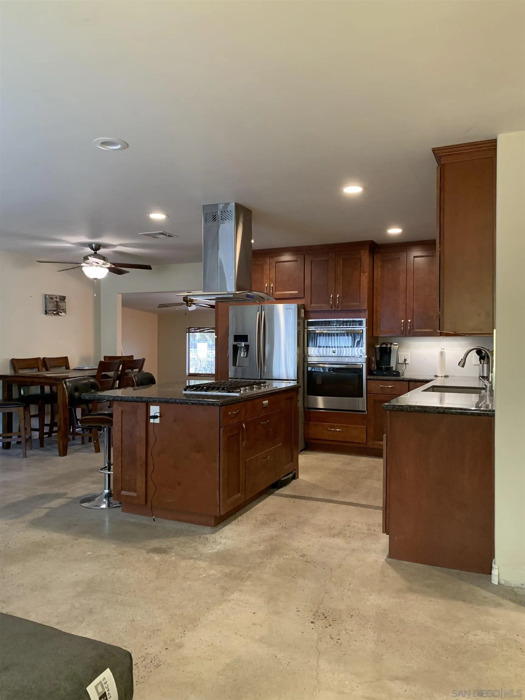 9935 Blossom Valley Road El Cajon, CA 92021 - Photo 23 of 36 a kitchen with stainless steel appliances kitchen island granite countertop a refrigerator and a stove