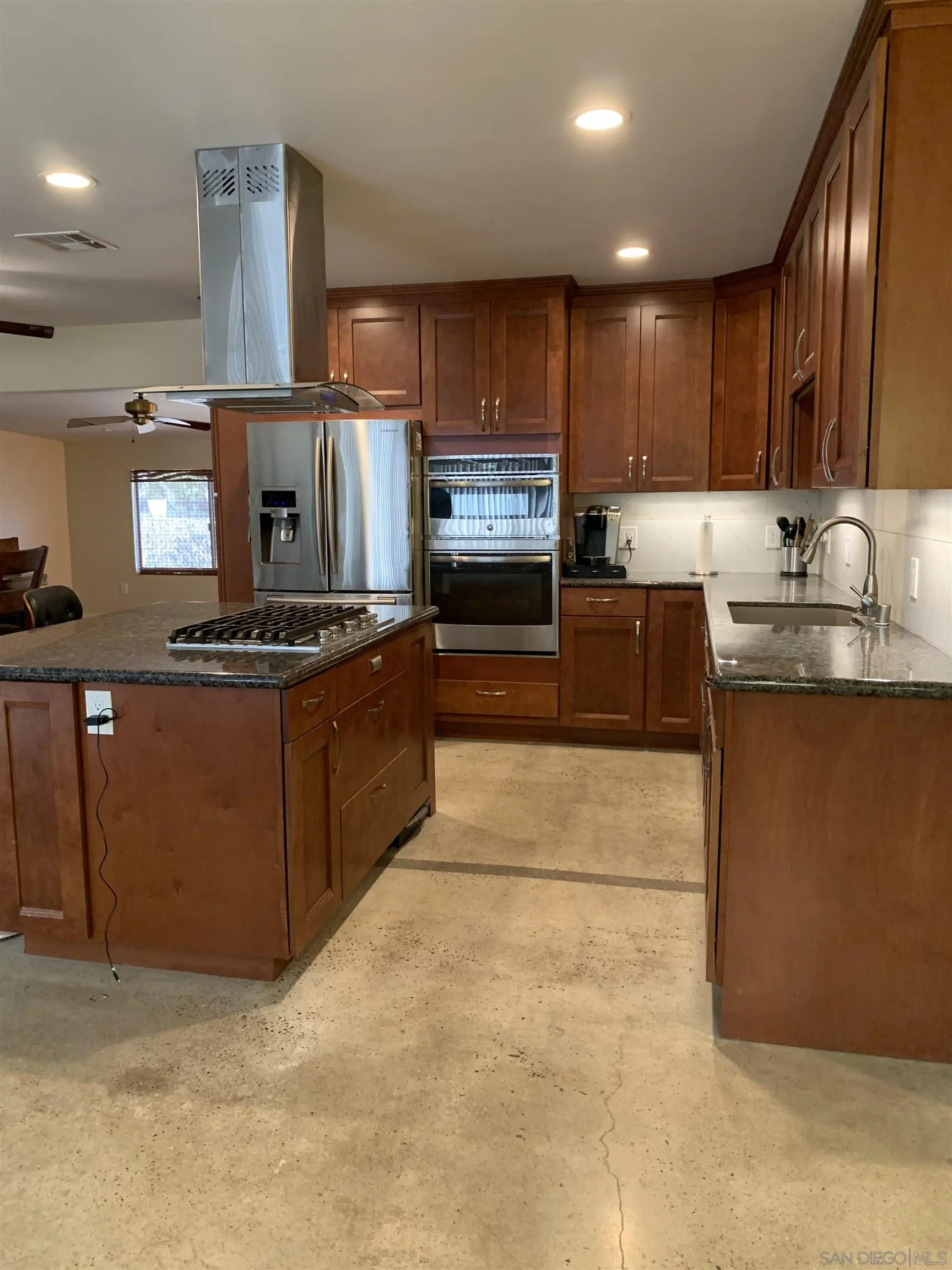9935 Blossom Valley Road El Cajon, CA 92021 - Photo 24 of 36 a kitchen with stainless steel appliances granite countertop a stove a sink and a microwave