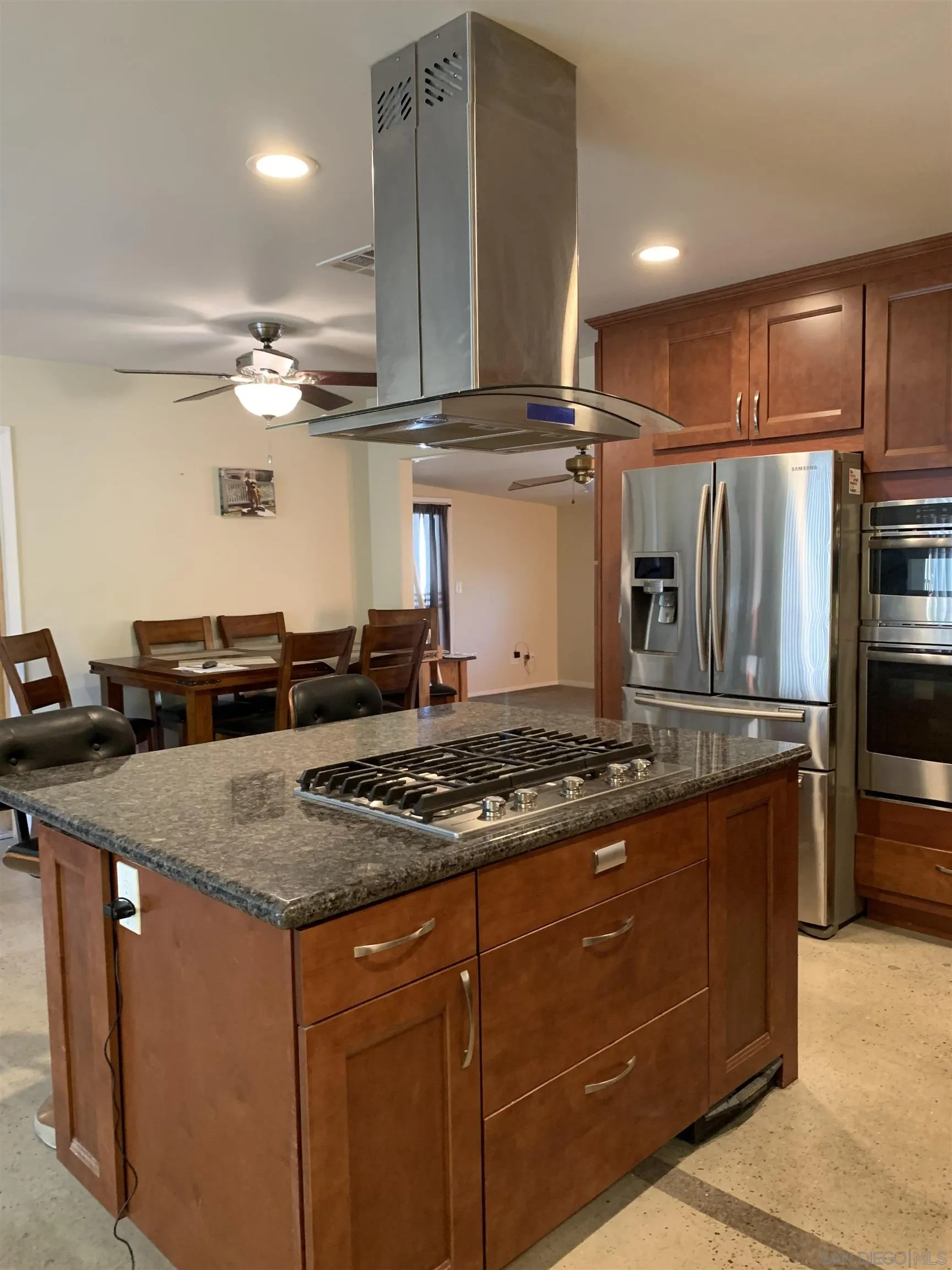 9935 Blossom Valley Road El Cajon, CA 92021 - Photo 25 of 36 a kitchen with stainless steel appliances granite countertop a sink stove and refrigerator