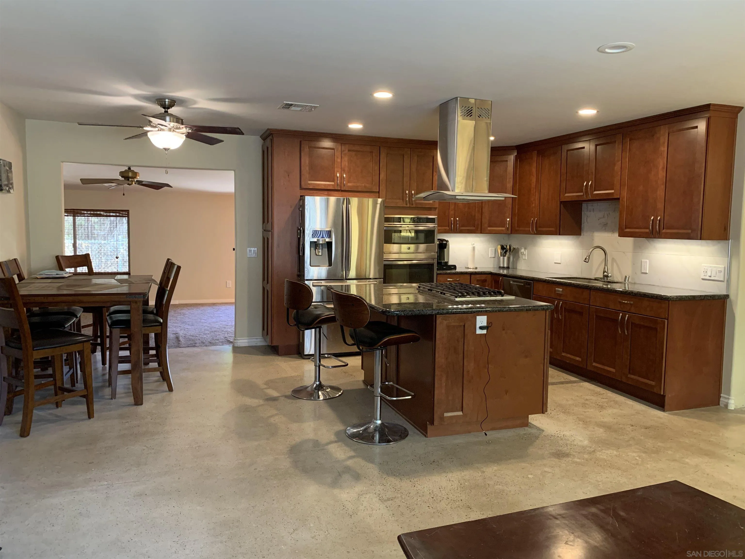 9935 Blossom Valley Road El Cajon, CA 92021 - Photo 3 of 36 a kitchen with kitchen island stainless steel appliances a sink and counter space