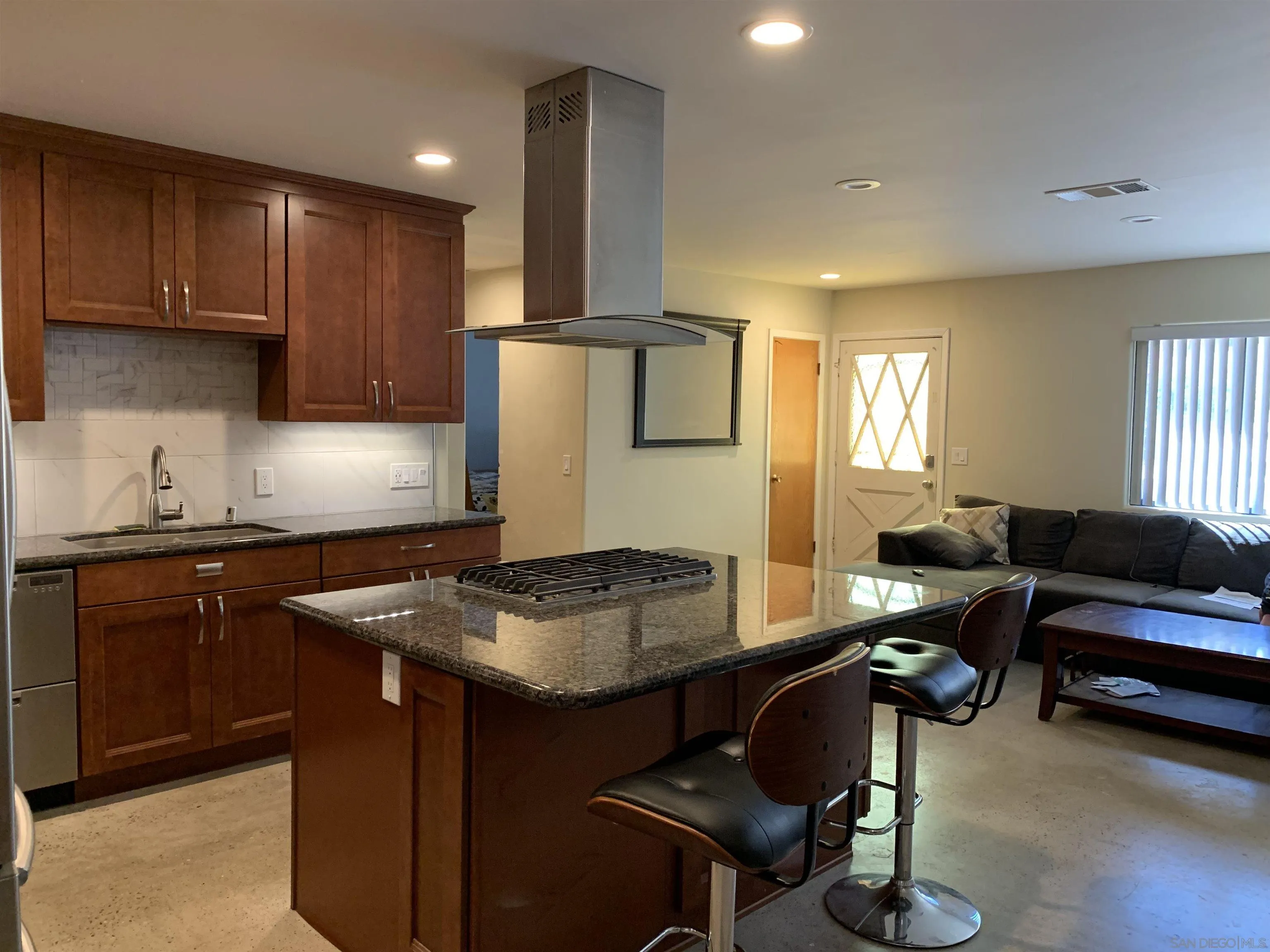 9935 Blossom Valley Road El Cajon, CA 92021 - Photo 4 of 36 a kitchen with a refrigerator and a stove top oven