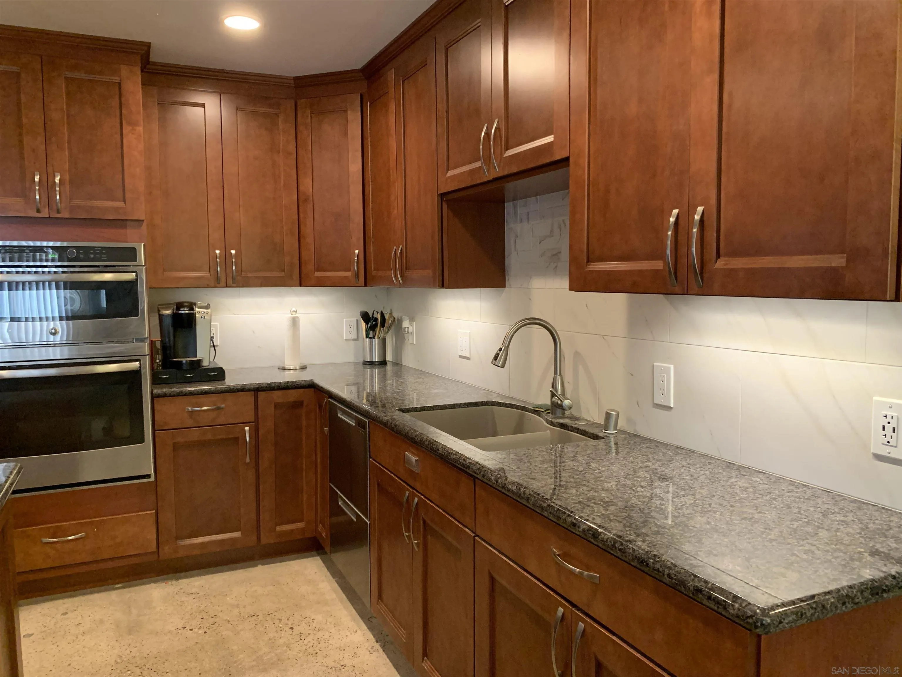 9935 Blossom Valley Road El Cajon, CA 92021 - Photo 5 of 36 a kitchen with granite countertop a sink a stove and cabinets