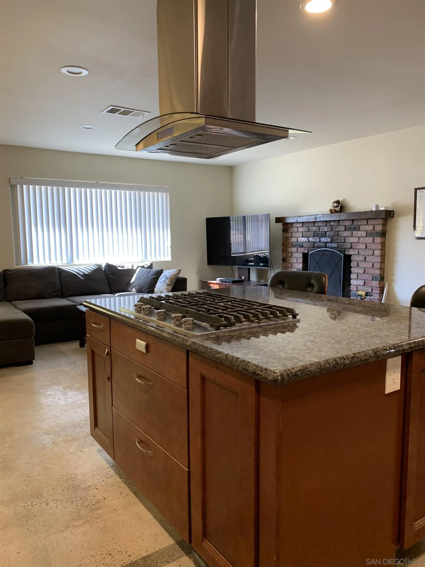 9935 Blossom Valley Road El Cajon, CA 92021 - Photo 10 of 36 a kitchen with granite countertop a sink a stove and a wooden cabinets