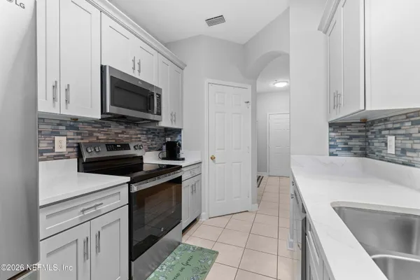 a kitchen with stainless steel appliances granite countertop a sink and a stove top oven with granite countertops