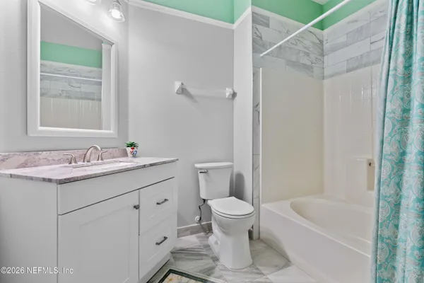 a bedroom with two beds and a chandelier