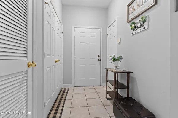 a view of an entryway with table and chair