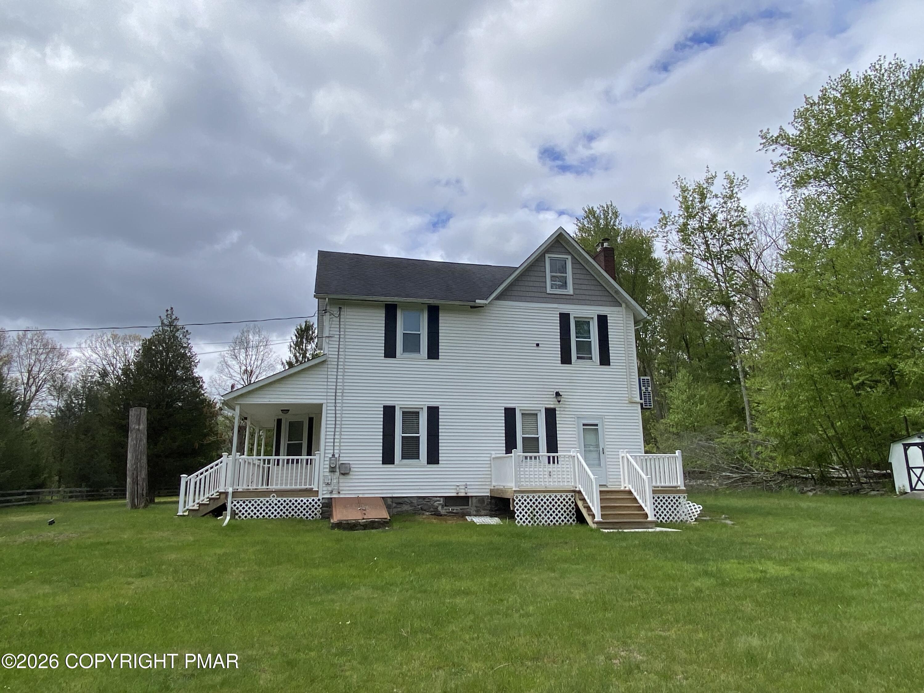 565 Cherry Lane Road East Stroudsburg, PA 18301 - Photo 4 of 16 a house view with a sitting space and garden