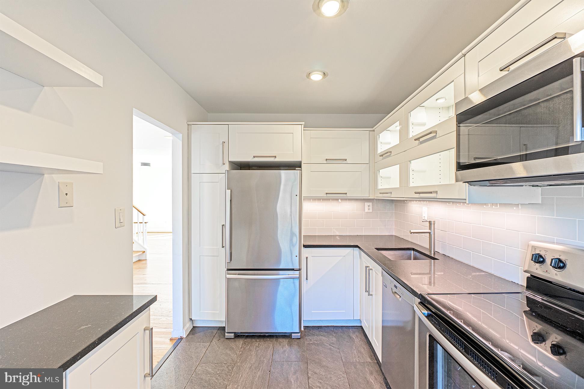 11495 Waterview Cluster Reston, VA 20190 - Photo 15 of 38 a kitchen with a refrigerator sink and stove