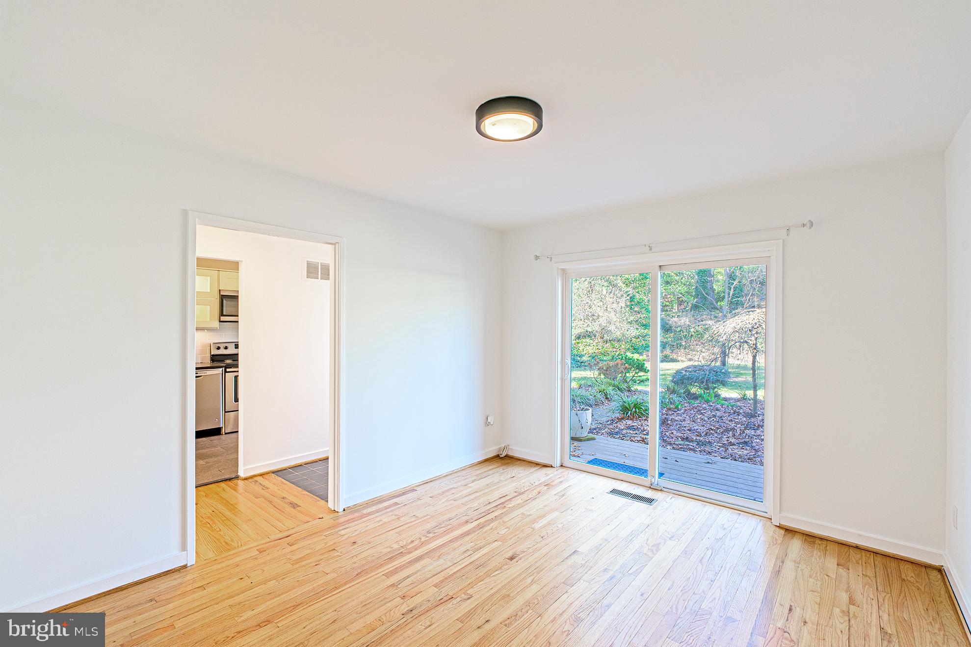 11495 Waterview Cluster Reston, VA 20190 - Photo 16 of 38 an empty room with wooden floor and windows