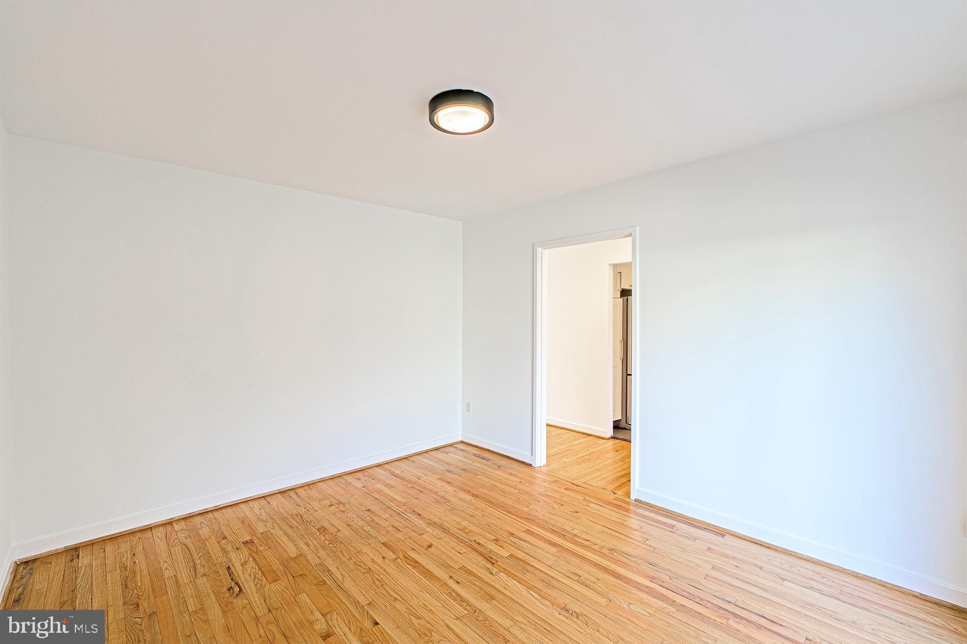 11495 Waterview Cluster Reston, VA 20190 - Photo 17 of 38 a view of empty room with wooden floor