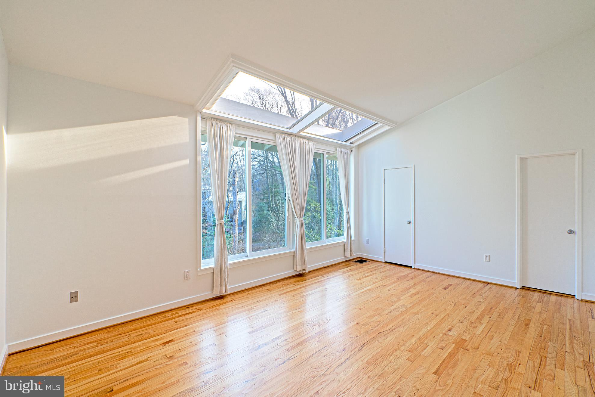 11495 Waterview Cluster Reston, VA 20190 - Photo 19 of 38 an empty room with wooden floor and door