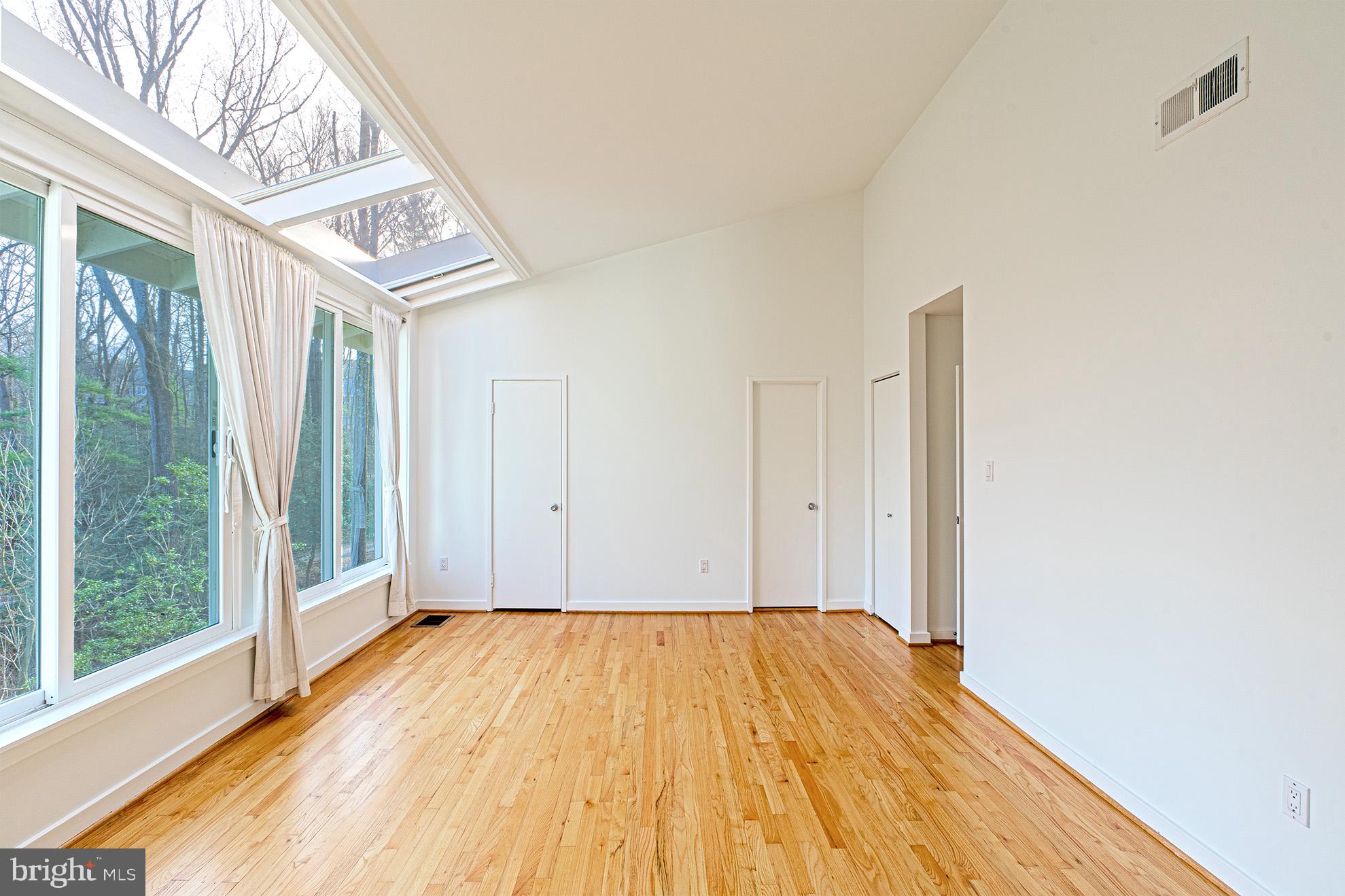 11495 Waterview Cluster Reston, VA 20190 - Photo 20 of 38 a view of a room with wooden floor and large windows