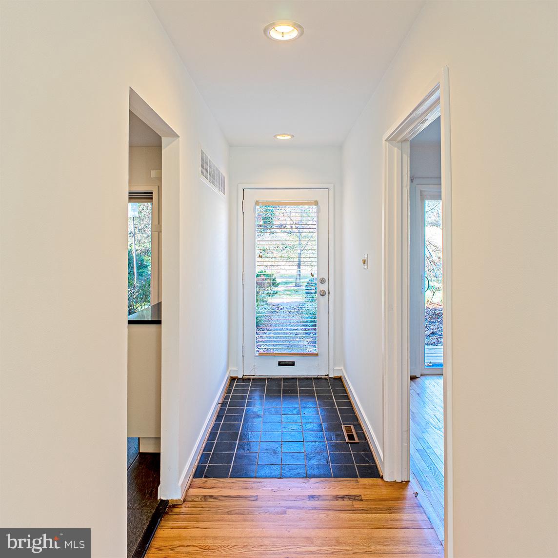 11495 Waterview Cluster Reston, VA 20190 - Photo 2 of 38 a view of a hallway with wooden floor and staircase
