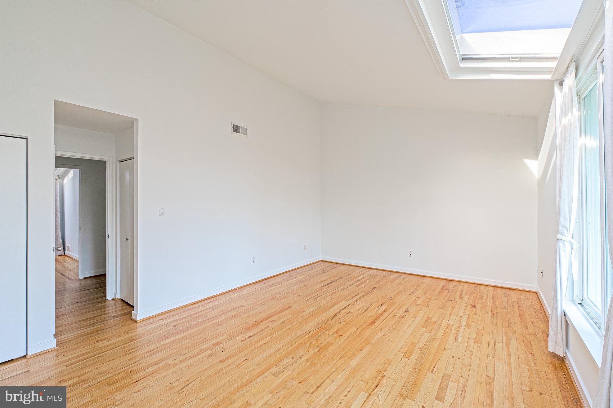11495 Waterview Cluster Reston, VA 20190 - Photo 21 of 38 a view of empty room with wooden floor and fan