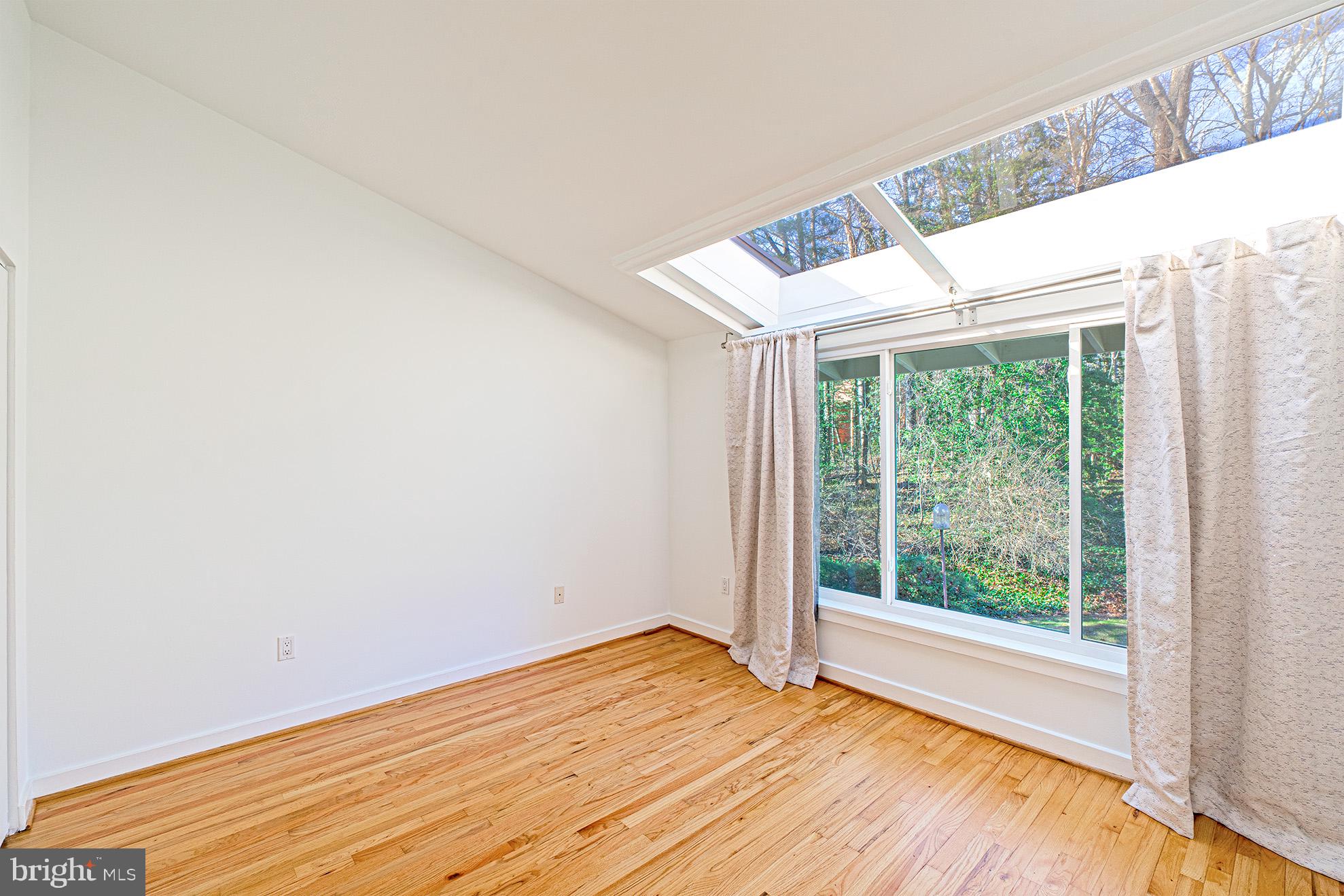 11495 Waterview Cluster Reston, VA 20190 - Photo 25 of 38 a view of empty room with wooden floor and fan
