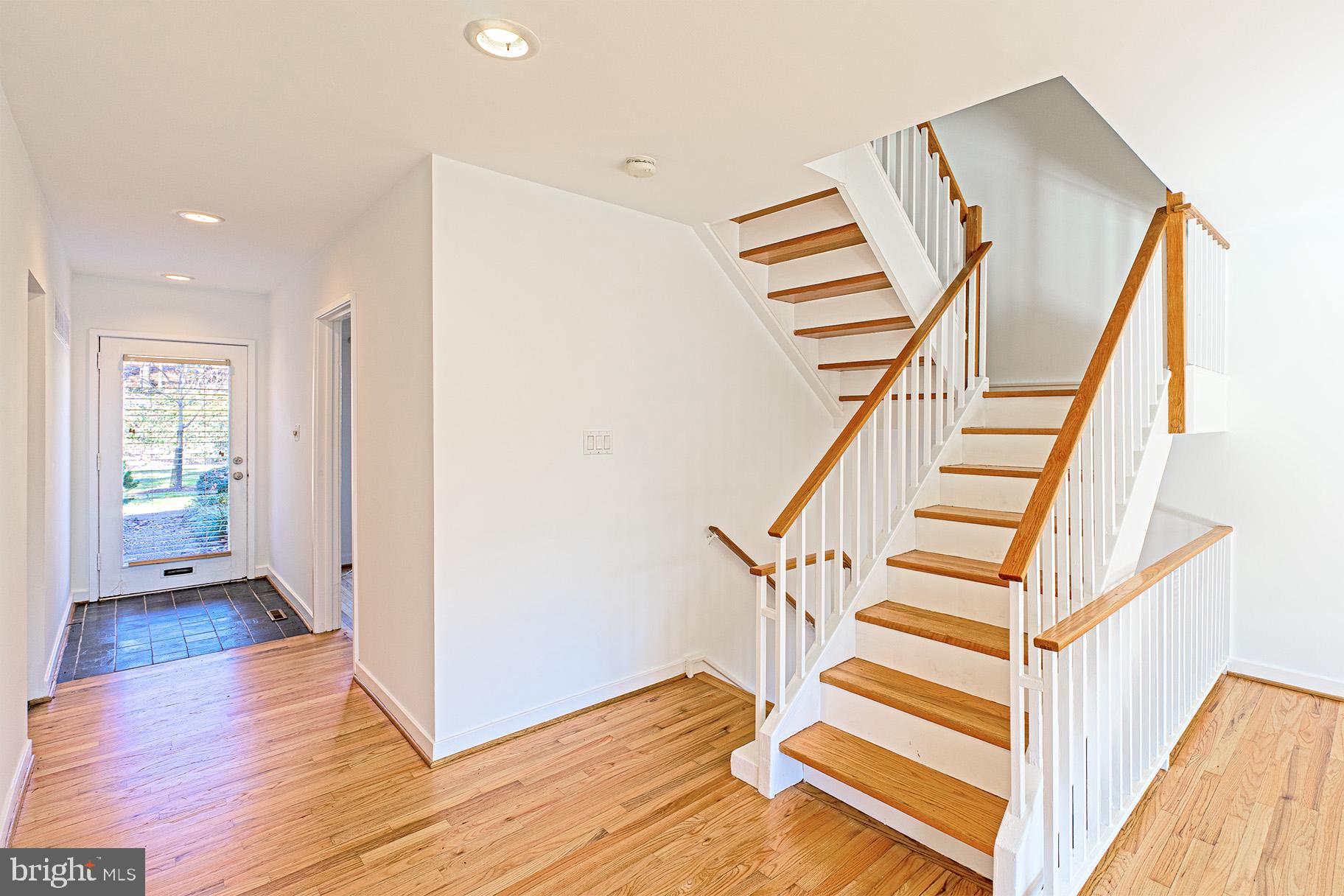 11495 Waterview Cluster Reston, VA 20190 - Photo 3 of 38 a view of entryway with wooden floor and stairs