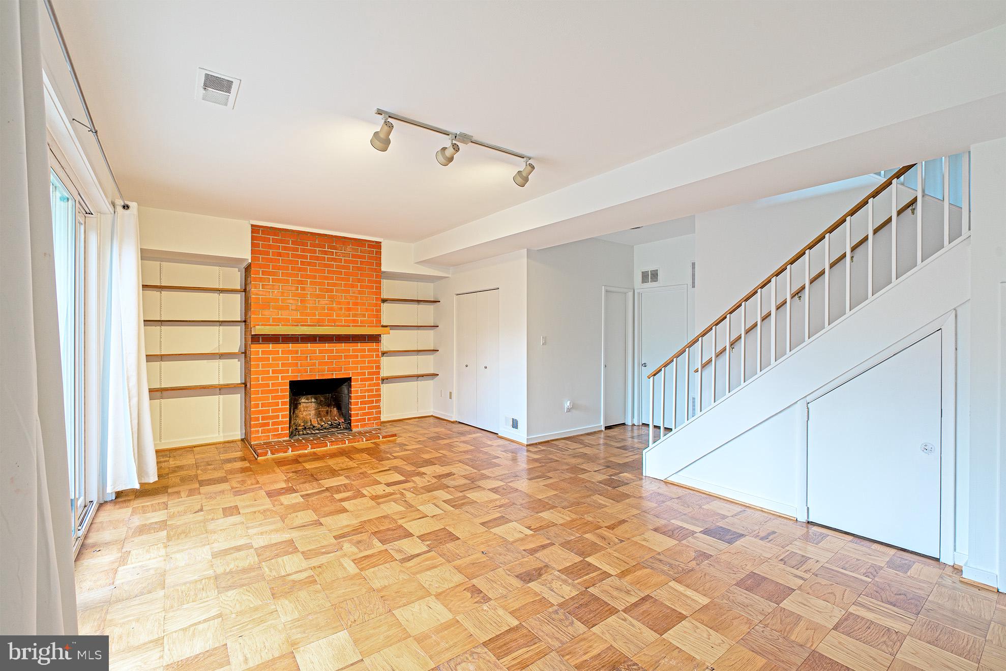 11495 Waterview Cluster Reston, VA 20190 - Photo 31 of 38 a view of a livingroom with wooden floor and staircase