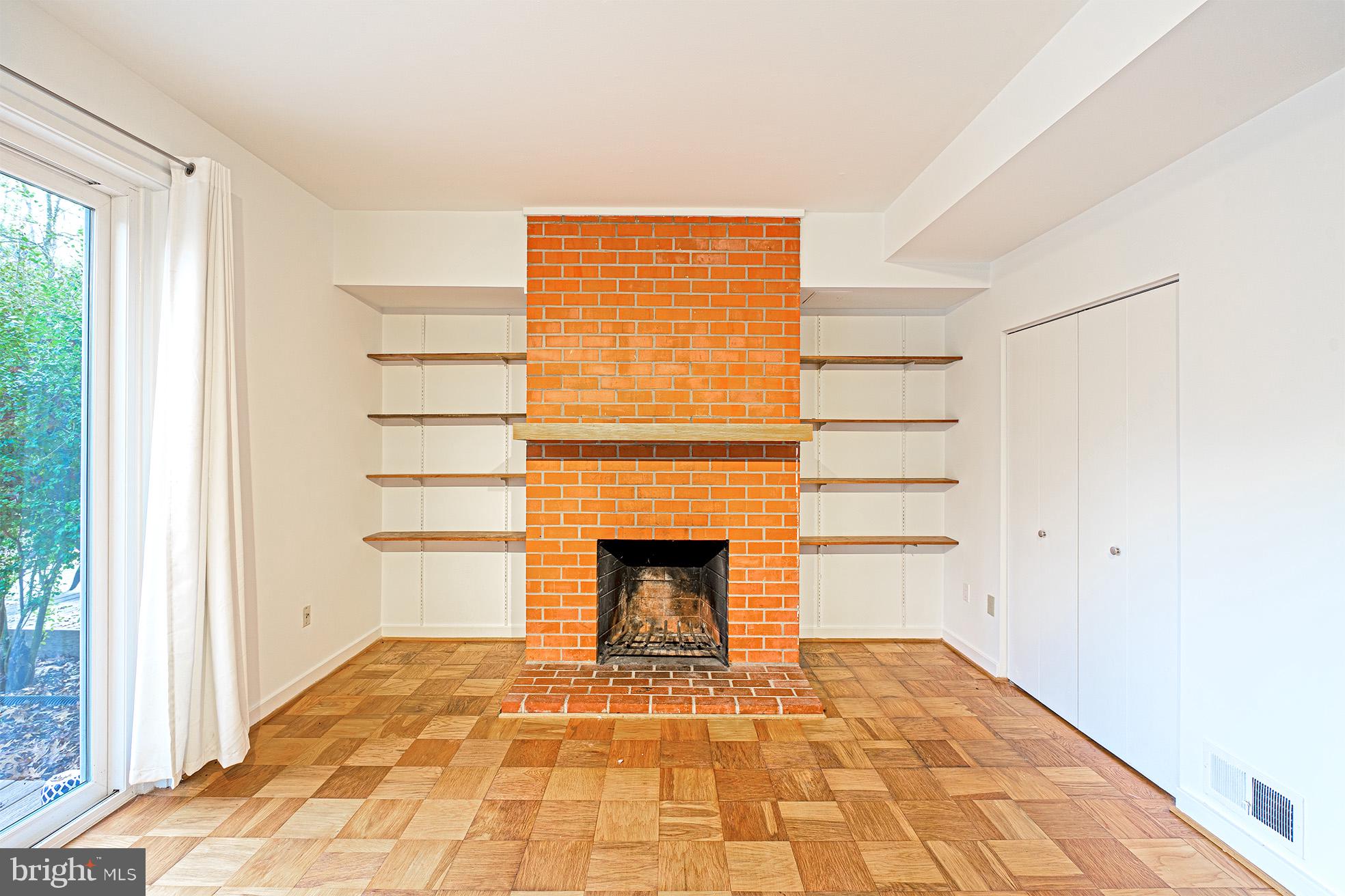 11495 Waterview Cluster Reston, VA 20190 - Photo 33 of 38 a view of empty room with wooden floor and fireplace