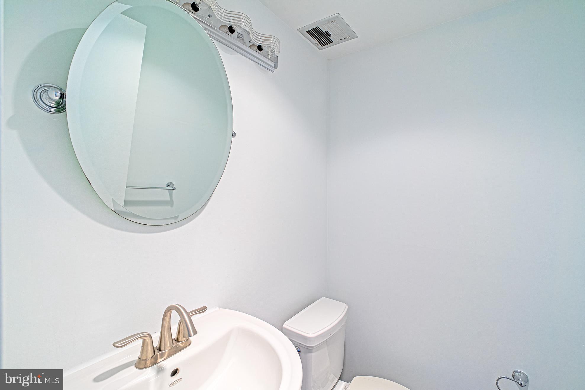 11495 Waterview Cluster Reston, VA 20190 - Photo 34 of 38 a bathroom with a sink mirror and toilet