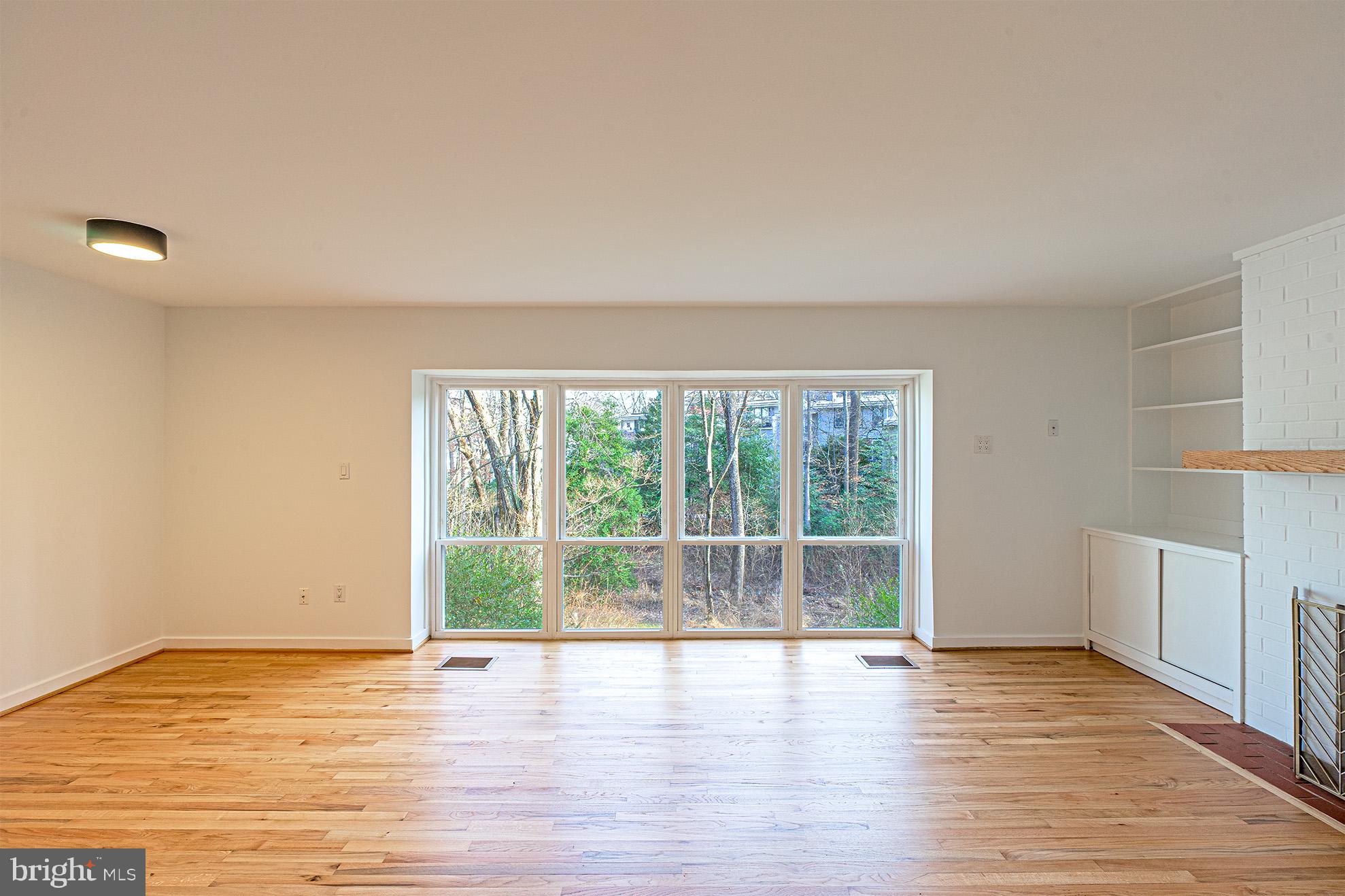 11495 Waterview Cluster Reston, VA 20190 - Photo 4 of 38 a view of empty room with wooden floor and fan