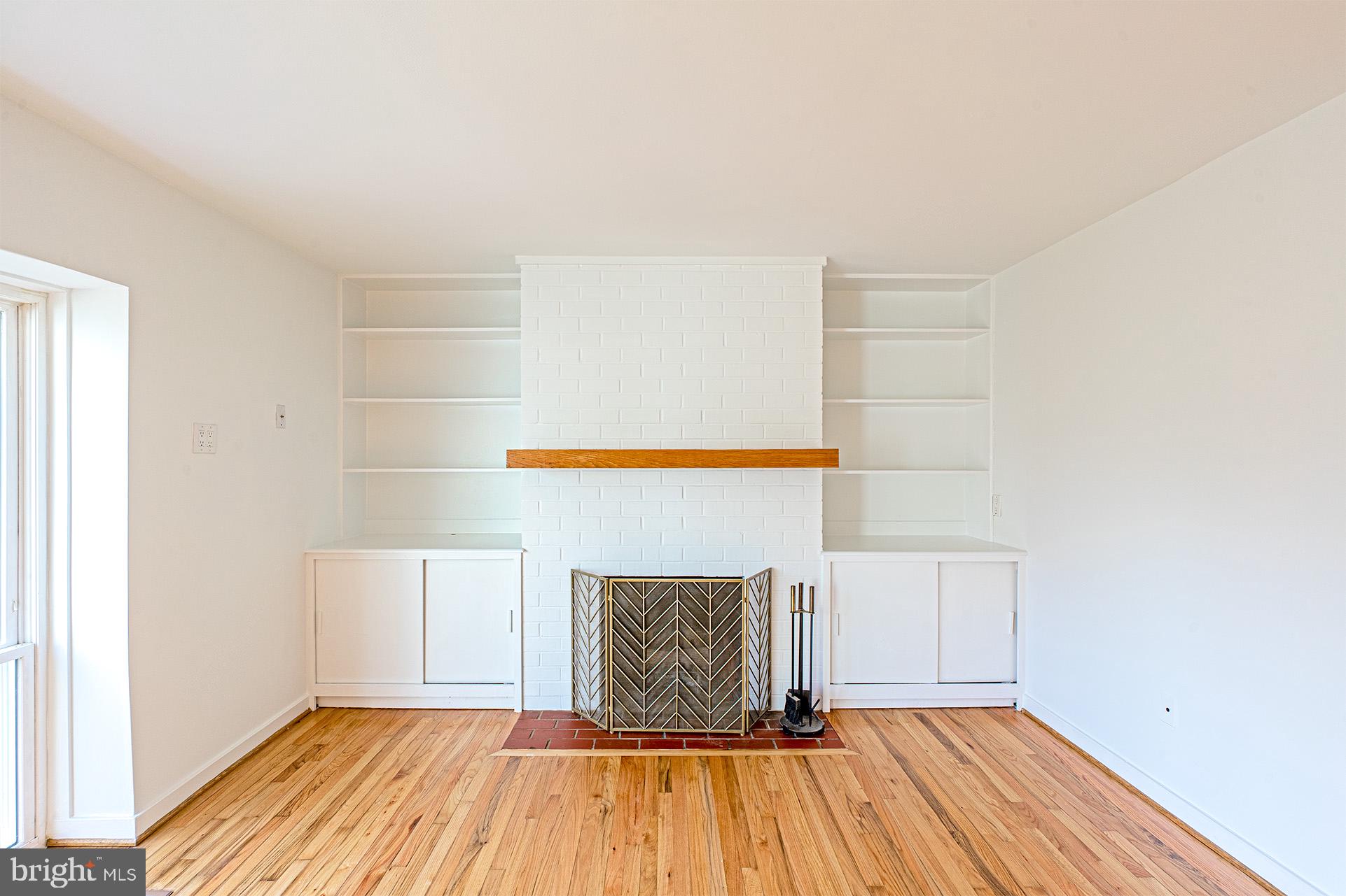 11495 Waterview Cluster Reston, VA 20190 - Photo 10 of 38 a view of a livingroom with wooden floor and a fireplace