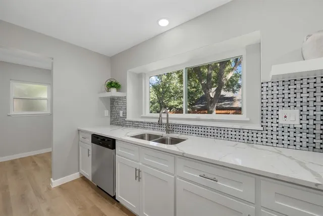 a kitchen with a sink and large window