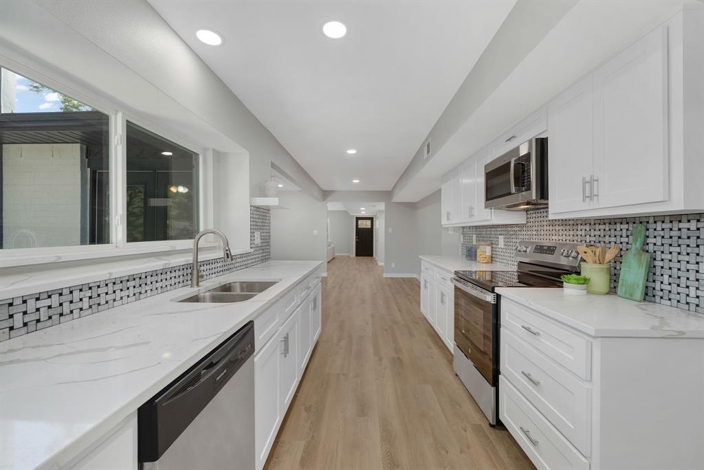 4213 Huckleberry Drive Fort Worth, TX 76137 - Photo 17 of 39 a large kitchen with stainless steel appliances granite countertop a lot of counter space and a sink