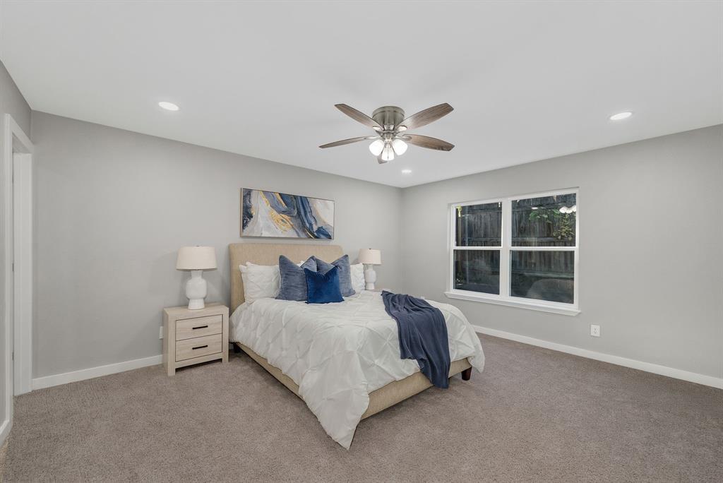 4213 Huckleberry Drive Fort Worth, TX 76137 - Photo 18 of 39 a bedroom with a bed and a large window