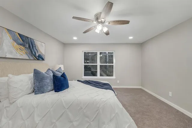 a bedroom with a large bed and a window