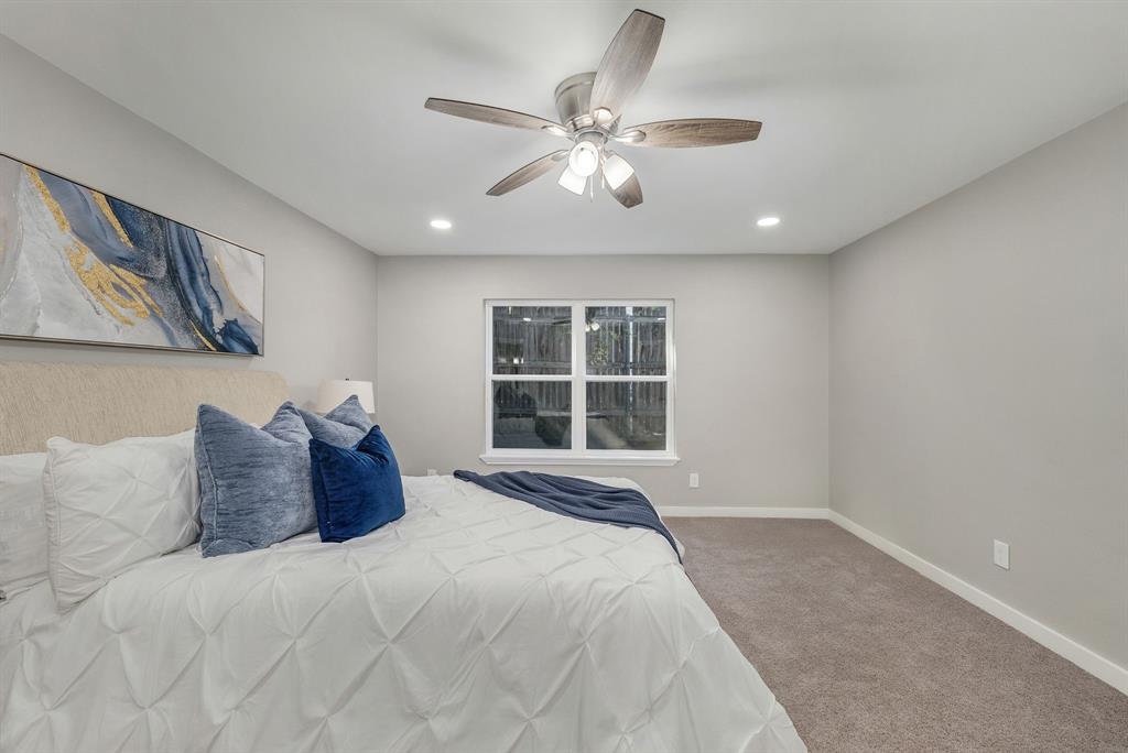 4213 Huckleberry Drive Fort Worth, TX 76137 - Photo 19 of 39 a bedroom with a large bed and a window