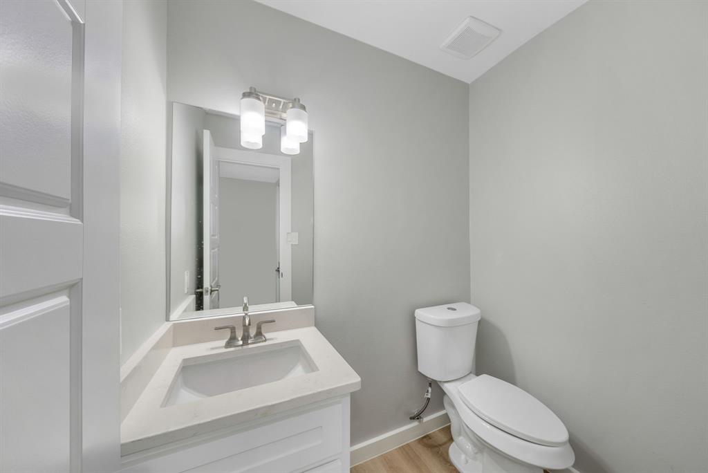 4213 Huckleberry Drive Fort Worth, TX 76137 - Photo 27 of 39 a bathroom with a toilet sink and mirror