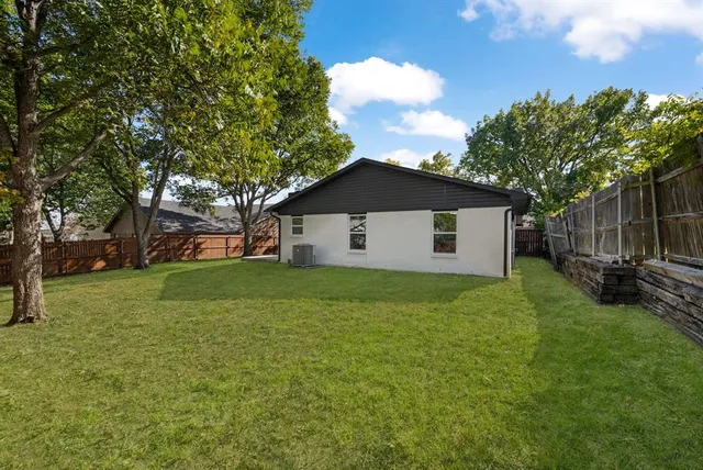 a view of a backyard with large trees