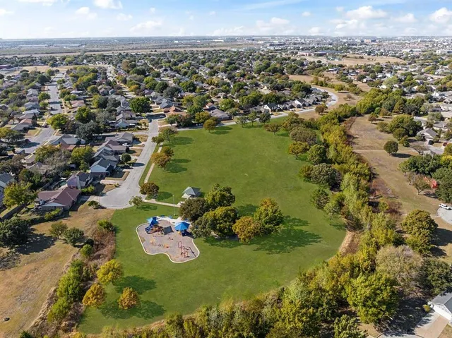 an aerial view of residential houses with outdoor space
