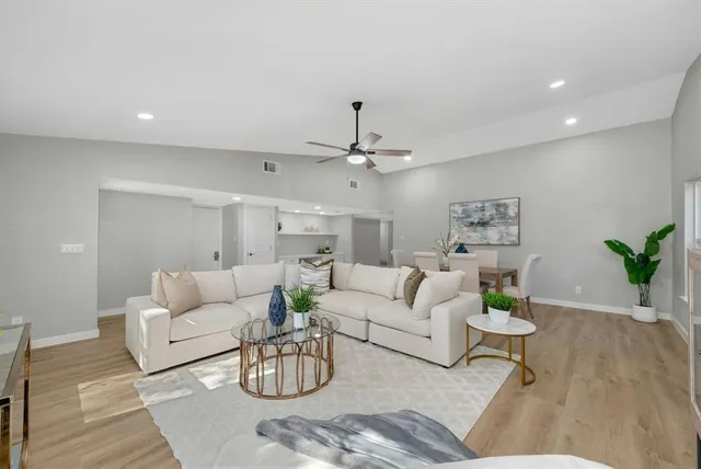 a living room with furniture and wooden floor