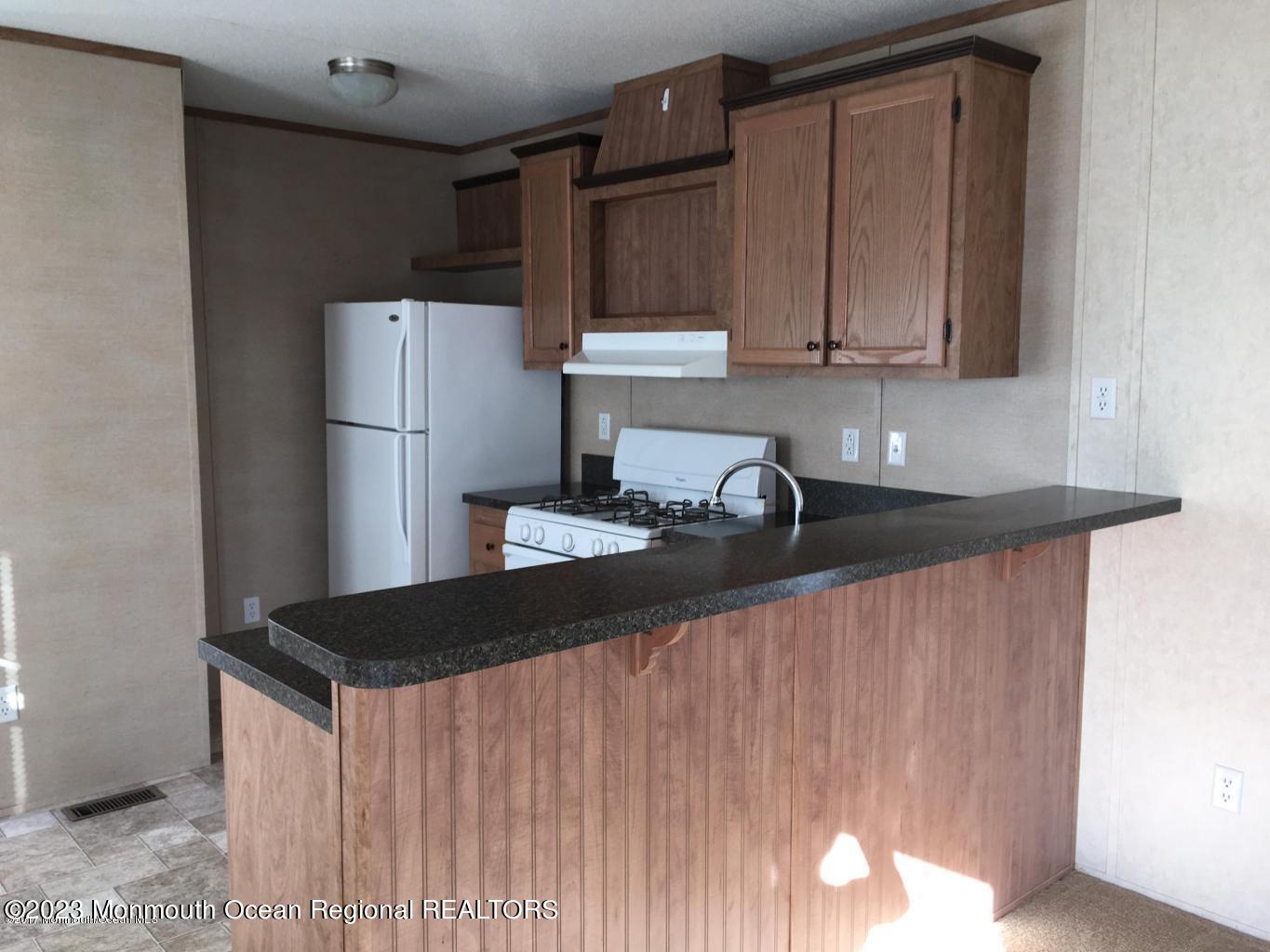 20 Monique Circle Hazlet, NJ 07730 - Photo 2 of 3 a kitchen with a refrigerator and a sink