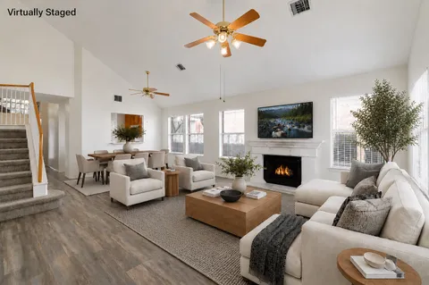 a living room with furniture fireplace and a flat screen tv