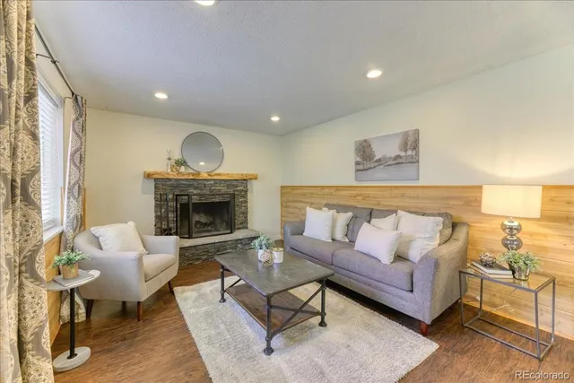 a living room with furniture and a fireplace
