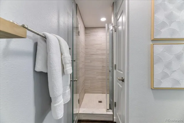 a bathroom with a shower and a mirror