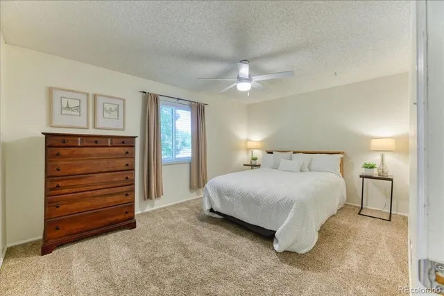 a spacious bedroom with a bed and a chandelier