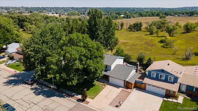 an aerial view of a house with garden space and lake view