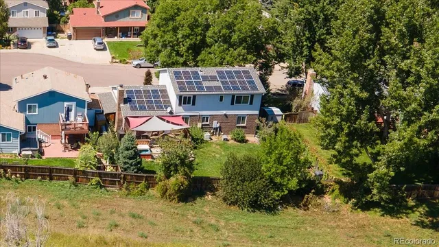 aerial view of a house with a yard and sitting area