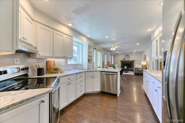 a kitchen with sink cabinets and stainless steel appliances
